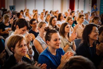 Women clapping hands at an event