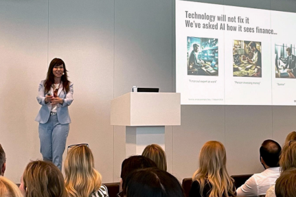 Olga Miler speaking in front of audience