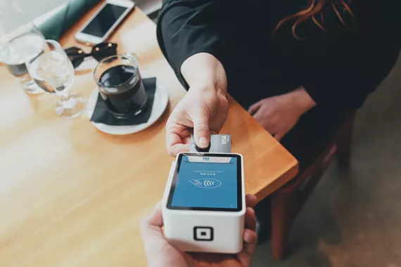Someone paying using a card machine